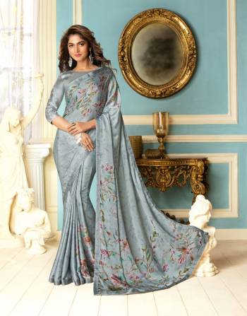 Flaunt Your Rich And Elegant Taste Wearing This Saree In Pale Grey Color Paired With Pale Grey Colored Blouse. This Saree And Blouse Are Fabricated On Fancy Fabric Beautified Floral Prints With Stone Work. 