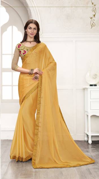 Celebrate This Festive Season Wearing This Designer Saree In Yellow Color Paired With Beige Colored Blouse. This Saree Is Fabricated On Chiffon Paired With Art Silk fabricated Blouse. It Has Contrasting Embroidery Over The Blouse. Buy This Saree Now.