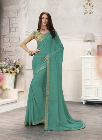 Here Is A Very Pretty Sahde In Blue With This Saree In Turquoise Blue Color Paired With Beige Colored Blouse. This Saree Is Fabricated On Chiffon Paired With Art Silk Fabricated Blouse. Its Pretty Color And Embroidery Will Earn You Lots Of Compliments From Onlookers.