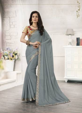 Flaunt Your Rich And Elegant Taste Wearing This Saree In Grey Color Paired With Beige Colored Blouse. This Saree Is Fabricated On Chiffon Paired With Art Silk Fabricated Blouse. It Is Beautified With Embroidery Over The Blouse And Saree. Buy This Saree Now.