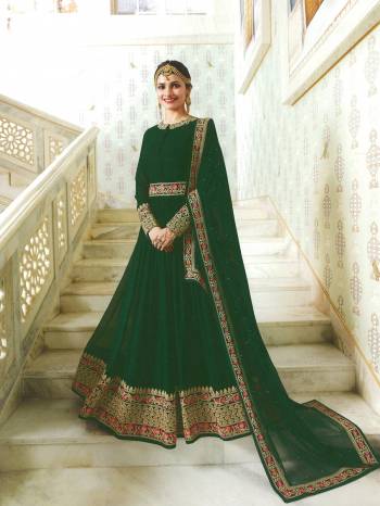 One Of The Finest Shade In Green Is Here With This Designer Floor Length Suit In Pine Green Color Paired With Pine Green Colored Bottom And Dupatta. Its Top Is Fabricated On Georgette Paired With Santoon Bottom And Chiffon Dupatta. It Has Heavy Multi Colored Embroidery Making The Suit More Attractive.