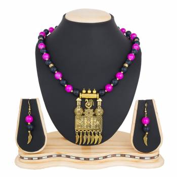 Designer Necklace Set Is Here In Pendant Pattern. It Is In Golden Color Beautified With Black And Pink Colored Motis.