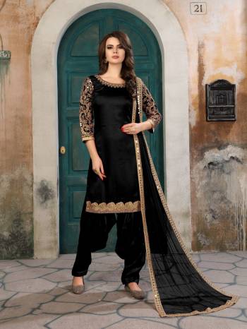 For A Bold And Beautiful Look, Grab This Designer Suit In Black Color Paired With Black Colored Bottom And Dupatta. Its Top Is Fabricated On Art Silk Paired With Santoon Bottom And Net Dupatta. Its Is Beautified With Attractive Embroidery Over The Sleeves, Panel and Dupatta. Buy This Suit Now.