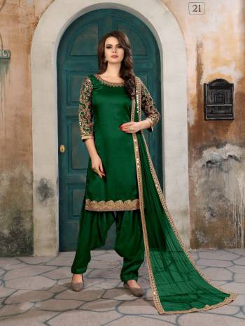 Attract All Wearing This Designer Straight Cut Suit In Dark Green Color Paired With Dark Green Colored Bottom And Dupatta. Its Top Is Fabricated On Art Silk Paired With Santoon Bottom And Net Dupatta. Buy This Attractive Looking Suit Now.