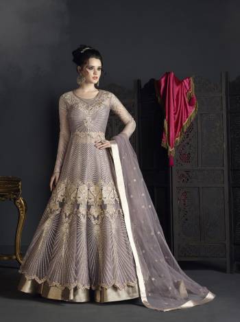 Flaunt Your Rich And Elegant Taste Wearing This Designer Suit In Grey Colored Top Paired With Grey Colored Bottom And Dupatta. Its Top Is Fabricated On Net Paired With Art Silk Fabricated Bottom And Net Fabricated Dupatta. Buy This Suit Now.It Is Beautiful Heavy Embroidery All Over Its Top Making The Suit More Attractive. 