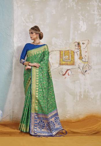 Grab This Lovely Silk Saree In Green Color Paired With Contrasting Blue Colored Blouse. This Saree And Blouse Are Fabricated On Art Silk Beautified With Weave All Over It. Buy Now.