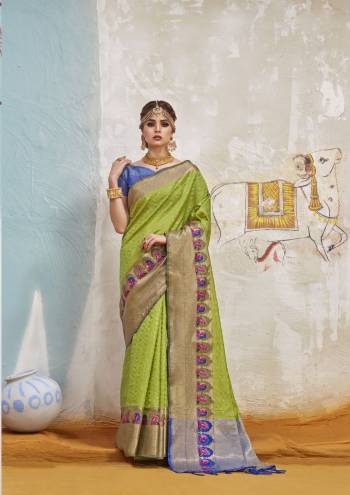 You Must Have A Silk Saree In Your Wardrobe Which Gives A Rich Look To Your Personality And Is Suitable In Any Occasion. Grab This Saree In Light Green color Paired With Contrasting Blue Colored Blouse. This Saree And Blouse Are fabricated On Art Silk Beautified With Weave All Over. 