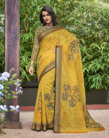 Look Attractive This Summer Wearing This Saree In Bright Yellow Color Paired With Contrasting Grey Colored Blouse. This Saree And Blouse Are Fabricated On Cotton Silk Beautified With Prints All Over It.