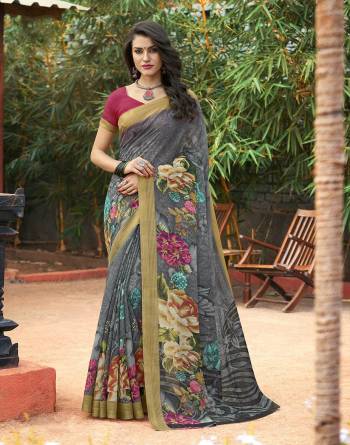 Add This Beautiful Saree To Your Wardrobe In Grey Color Paired With Contrasting Magenta Pink Colored Blouse. This Saree And Blouse Are Fabricated On Cotton Silk Beautified With Floral Prints all Over It. Buy Now.