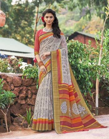 If You Are Fond Of Light Colors Than Grab This Saree In Pale Grey Color Paired With Contrasting Peach Colored Blouse. This Saree And Blouse Are Fabricated On Cotton Silk Beautified With Prints All Over It. Buy Now.