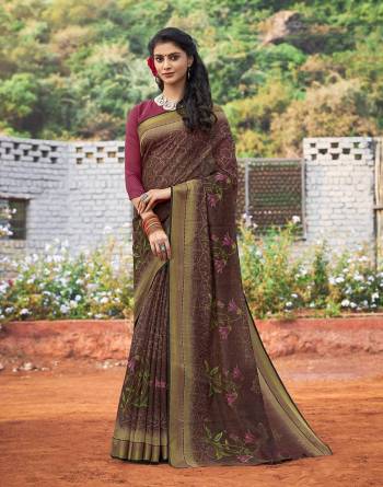 Attract All Wearing This Saree In Dark Brown Color Paired With Contrasting Magenta Pink Colored Blouse. This Saree And Blouse Are Fabricated On Cotton Silk Beautified With Floral Prints All Over It. Buy Now.