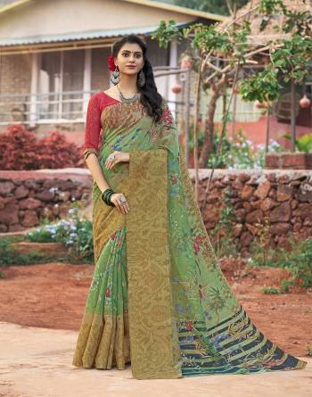 A Very Pretty Shade On Green Is Here With This Saree In Mint Green Color Paired With Contrasting Red Colored Blouse. This Saree And Blouse Are Fabricated On Cotton Silk Beautified With Prints All Over It. Buy Now.