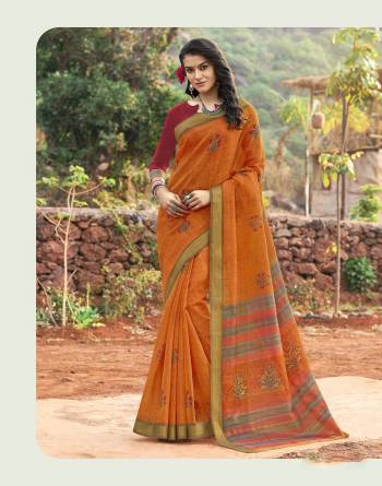 Orange Color Induces Perfect Summery Appeal To Any Outfit So Grab This Saree In Orange Color Paired With Contrasting Maroon Colored Blouse. This Saree And Blouse Are Fabricated On Cotton Silk Beautified With Prints All Over It.