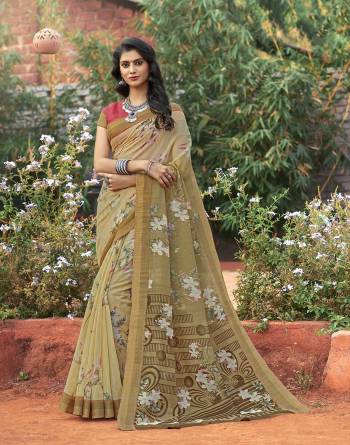 Add This Decent And Rich Looking Saree In Cream Color Paired With Peach Colored Blouse. This Saree And Blouse Are Fabricated On Cotton Silk Beautified With Floral Prints. 