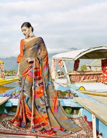 Go Colorful In This Lovely Multi Colored Saree Paired With Orange Colored Blouse. This Saree Has Weightless Fabric Paired With Art Silk Fabricated Blouse. It Is Beautified With Prints All Over It. Buy Now.