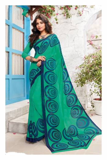 Add This Casual Saree To Your Wardrobe In Sea Green Color Paired With Sea Green Colored Blouse. This Saree And Blouse Are Fabricated On Georgette Beautified With Prints All Over It. 