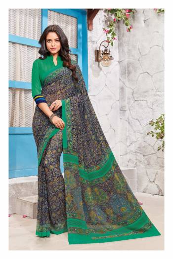 Here Is A Beautiful Saree With Intricate Prints In Blue Color Paired With contrasting Green Colored Blouse. This Saree And Blouse Are Fabricated On Georgette Beautified With Intricate Floral Prints All Over It. Buy This Saree Now.