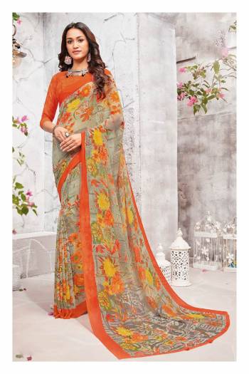 New And Unique Combination Is Here With This Printed Saree In Grey And Orange Color Paired With Orange Colored Blouse. This Saree And Blouse Are Fabricated On Georgette Beautified With Contrasting Floral Prints all Over It.