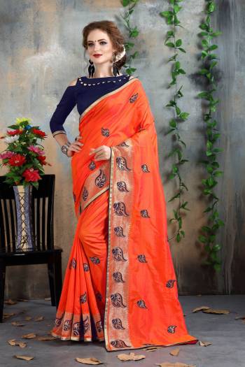 Orange Color Induces Perfect Summery Appeal To Any Outfit, So Grab This Attractive Saree In Orange Color Paired With Contrasting Navy Blue Colored Blouse. This Saree And Blouse Are Fabricated On Art Silk Beautified With Attractive Jari And Thread Embroidery. Buy Now.