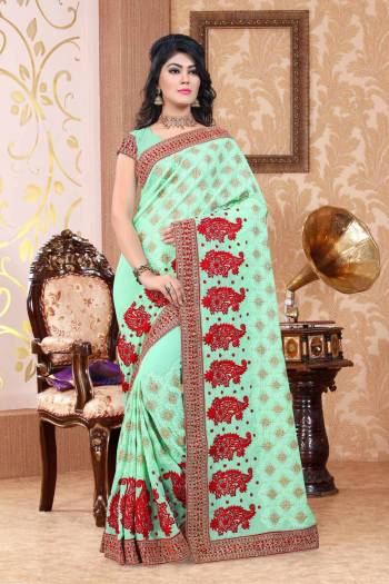 This Season Is About Subtle Shades And Pastel Play, So Grab This Designer Saree In Pastel Green Color Paired With Pastel Green Colored Blouse. This Saree And Blouse Are Fabricated On Georgette Beautified With Contrasting Embroidery All Over. Buy This Saree Now.