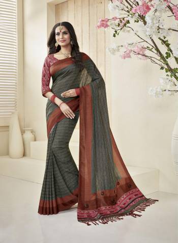 Here Is A Very Beautiful Saree In Dark Grey Color Paired With Contrasting Maroon Colored Blouse. This Saree And Blouse Are Fabricated On Cotton Khadi Beautified With Prints. It Is Easy To Drape And Easy To Care For.