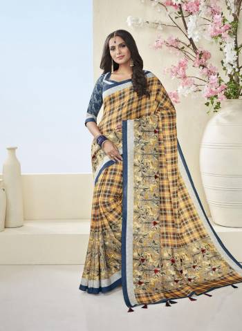 Checks Pattern Is Here With This Pretty Designer Saree In Yellow Color Paired With Contrasting Blue Colored Blouse. This Saree And Blouse Are Fabricated On Cotton Khadi Beautified With Checks and Floral Prints All Over It. Buy Now.