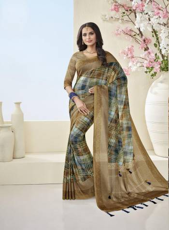 Another Beautiful Saree Is Here In Checks Prints. Grab This Saree In Light Brown And Blue Color Paired With Light Brown Colored Blouse. This Saree And Blouse Are Fabricated On Cotton Khadi Beautified With Checks Prints. Buy This Saree Now.