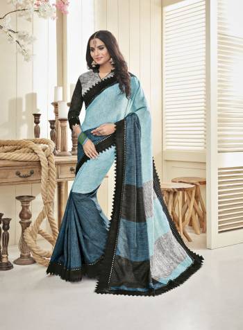 Look Beautiful In This Saree In Shades Of Blue Paired With Grey And Black Colored Blouse. This Saree And Blouse Are Fabricated On Cotton Khadi. It Is Light Weight, Durable and Easy To care For.