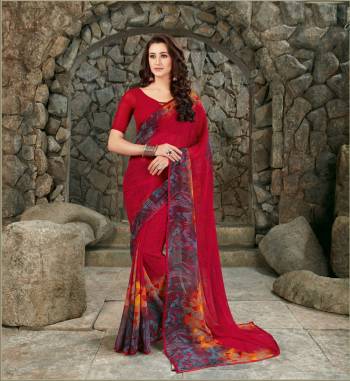 Adorn The Pretty Angelic Look Wearing This Saree In Red Color Paired With Red Colored Blouse, This Saree And Blouse Are Fabricated On Georgette Beautified With Floral Prints Over The Border.