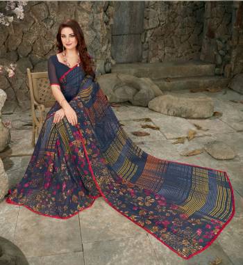 Enhance Your Personality Wearing This Printed Saree In Blue Color Paired With Blue Colored Blouse. This Saree And Blouse are Fabricated On Georgette Beautfied With Geomteric And Floral Prints. 