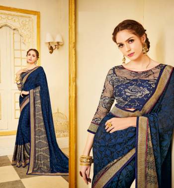 Enhance Your Personality Wearing this Designer Saree In Navy Blue Color Paired With Navy Blue Colored Blouse. This Saree Is Fabricated On Georgette Paired With Net Fabricated Blouse. It Is Beautified With Prints And Lace Border. 