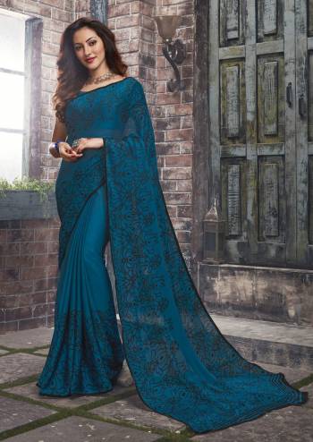 Adorn The Pretty Angelic Look Wearing This Saree In Blue Color Paired With Blue Colored Blouse. This Saree And Blouse Are Fabricated On Chiffon Beautified With Simple Floral Prints All Over It. This Saree Is Light In Weight And Also Easy To Carry All Day Long. 