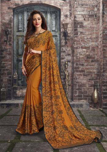 Adorn The Pretty Angelic Look Wearing This Saree In Musturd Yellow Color Paired With Musturd Yellow Colored Blouse. This Saree And Blouse Are Fabricated On Chiffon Beautified With Simple Floral Prints All Over It. This Saree Is Light In Weight And Also Easy To Carry All Day Long. 