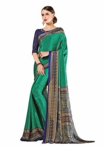 Look Attractive Wearing This Lovely Saree In sea Green Color Paired With Contrasting Navy Blue Colored Blouse. This Saree And Blouse Are Fabricated On Crepe Beautified With Prints All Over It. Buy This Elegant Saree Now.