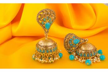 A Very Pretty Pair Of Earrings Is Here With This Jhumka Styled Golden Colored Earrings Beautified With Aqua Blue Colored Stone Work.