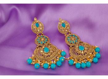 A Very Pretty Pair Of Earrings Is Here With This Heavy Golden Colored Earrings Beautified With Aqua Blue Colored Stone Work.