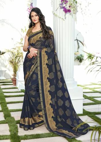 Enhance Your Personality Wearing This Saree In Navy Blue Color Paired Witth Golden Colored Blouse. This Lovely Saree Is Fabricated On Chiffon Jacquard Paired With Brocade Fabricated Blouse. This Saree IS Easy To Drape And Easy To Care For.