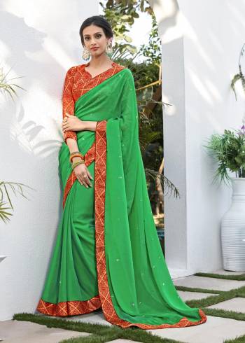 For A Simple Traditional Look, Grab This Saree In Green Color Paired With Contrasting Orange Colored Blouse. This Traditional Color Combination Will earn You Lots Of Compliments From Onlookers. Its Saree Is Fabricated On Chiffon Jacquard Paired With Brocade Fabricated BLouse.