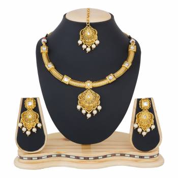 You Will Definitely Earn Lots Of Compliments Wearing This Designer And Elegant Looking Necklace Set In Golden Color Beautified With White Colored Stones. Buy This Rich Looking Necklace Set Now.