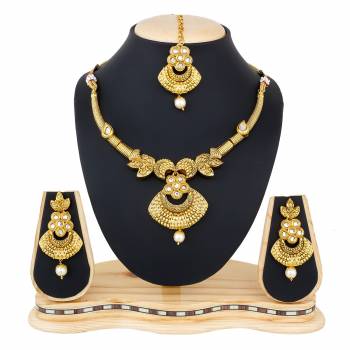 You Will Definitely Earn Lots Of Compliments Wearing This Designer And Elegant Looking Necklace Set In Golden Color Beautified With White Colored Stones. Buy This Rich Looking Necklace Set Now.