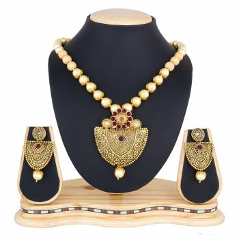 Royal Looking Necklace Set Is Here In Golden Color. This Designer Necklace Set Is Beautified With Maroon Colored Stones. Pair This Up With Your Maroon Colored Ethnic Attire And Look Like A Queen.