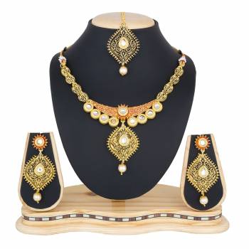 You Will Definitely Earn Lots Of Compliments Wearing This Designer And Elegant Looking Necklace Set In Golden Color Beautified With White Colored Stones. Buy This Rich Looking Necklace Set Now.