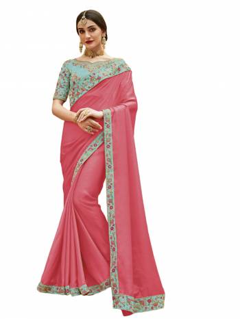 Another Pretty Shade Is Here To Add Up Into Your Wardrobe In Pink Color Paired With Contrasting Aqua Blue Colored Blouse. This Saree Is Fabricated On Satin Silk Paired With Art Silk Fabricated Blouse. It Is Beautified With Multi Colored Embroidery Over The Blouse And Lace Border.