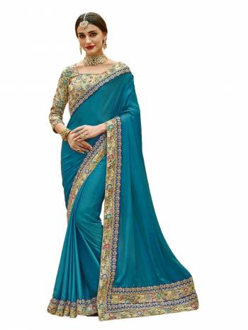 This Pretty Designer Saree Will Definitely Earn You Lots Of Compliments From Onlookers. Grab This Beautiful Turquoise Blue Colored Saree Paired With Beige Colored Blouse. This Saree Is Fabricated On Satin Silk Paired With Art Silk Fabricated Blouse. It HAs Multi Colored Embroidery Over The Blouse And Saree Lace Border.