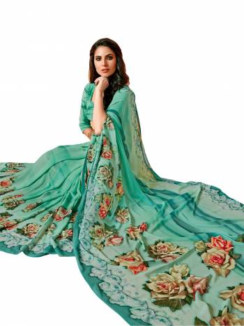 Truly A Pretty Shade In Blue Is Here With This Aqua Blue Colored Saree Paired With Aqua Blue Colored Blouse, This Saree And Blouse Are Fabricated On Georgette Beautified With Contrasting Pink Colored Bold Floral Prints All Over The Saree And Blouse.