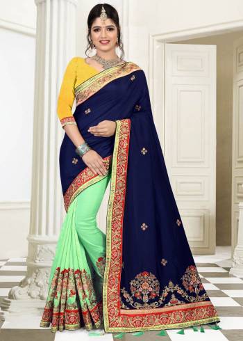 Go Colorful With This Designer Saree In Navy Blue And Pastel Green Color Paired With Contrasting Yellow Colored Blouse. This Saree Is Fabricated On Silk Paired With Art Silk Fabricated Blouse. It Has Attractive Heavy Embroidery Over The Saree Which will Earn You Lots Of Compliments From Onlookers.