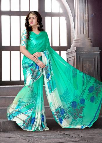 Look Wearing This Saree In Lovely Green Shade That Is Sea Green Color Paired With Sea Green colored Blouse. This Saree And Blouse are Fabricated On Satin Silk Beautified With Prints. Buy This Saree Now.