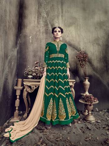 Dark And Attractive Shade In Green Is Here With This Designer Indo-Western Suit In Pine Green Color Paired With Beige Colored Bottom And Dupatta. Its Top Is Fabricated On Georgette Paired With Art Silk Bottom And Chiffon Dupatta. It Is Beautified With Heavy Jari And Resham Embroidery. 

