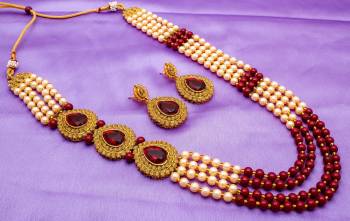 Adorn the Royal Queen Look With This Rich Looking Necklace Set In golden And Maroon Color. This Necklace Set Can Be Paired With Any Ethnic Attire In Maroon Or Any Contrasting Color. Buy Now.