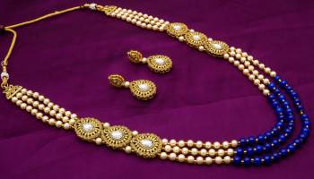 Enhance Your Traditonal Look Pairing It With This Beautiful Necklace Set In Golden And Blue Color Beautified With Moti And Stone Work. Buy This Set Now.